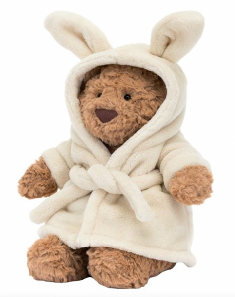 Bartholomew Bear, dressed in a fleece-soft Jellycat Bartholomew Bear Bathrobe with charming bunny ears, sits upright against a white background, embodying the essence of Self-Care Sunday.