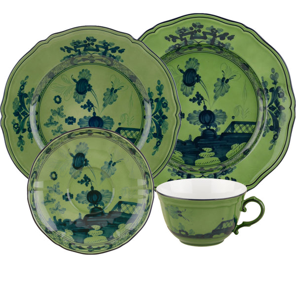 The GINORI 1735 Oriente Italiano Malachite Collection by Ginori 1735 features a set of green ceramic dishes with a dark green floral and decorative pattern, inspired by the Oriente Italiano collection. This exquisite set includes a cup, saucer, and three different-sized plates.