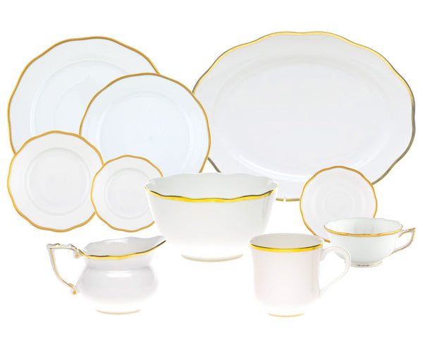 A set from the Herend Gwendolyn White and Gold Collection, comprising plates, cups, a bowl, and a creamer.