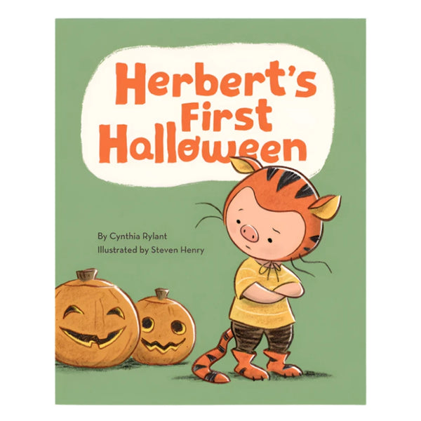 The book cover of "Herbert's First Halloween" by Cynthia Rylant, illustrated by Steven Henry, from Chronicle Books, depicts Herbert dressed in a tiger costume standing beside two carved pumpkins against a green backdrop, ready to join the trick-or-treaters.