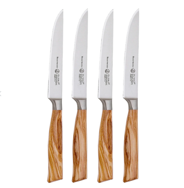 The Messermeister Oliva Elite Fine Edge Steak Knife Set, consisting of four pieces, features light wood handles and is crafted from premium German stainless steel for precision and durability.