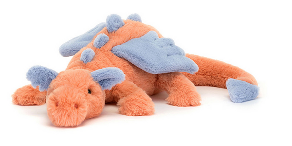 A Jellycat Persimmon Snow Dragon, Large with blue wings and spikes lies softly against a plain backdrop, making it a charming piece for nursery decor.