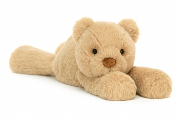 A Jellycat Smudge Bear, Medium, with soft fluff, lies on its stomach with its front paws stretched out in front, ready to snuggle up.