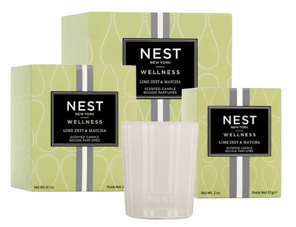 Three NEST Lime Zest and Matcha Candle Collection boxes from Nest are displayed, showcasing the invigorating collection. A clear candle holder in front adds a burst of energy to the scene.