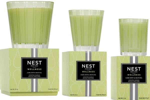 Three NEST Lime Zest and Matcha Candle Collection items from Nest are displayed, each with varying sizes of candle holders and packaging, offering invigorating scents for an energizing boost.