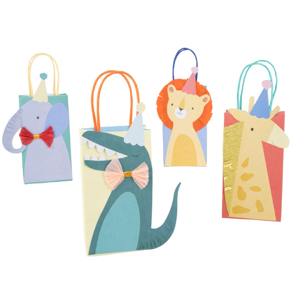 Four Meri Meri Party Bags designed to resemble animals—an elephant, a crocodile, a lion, and a giraffe—each wearing a party hat and bow tie. Featuring fun illustrations, these bags come with twisted paper handles for easy carrying.