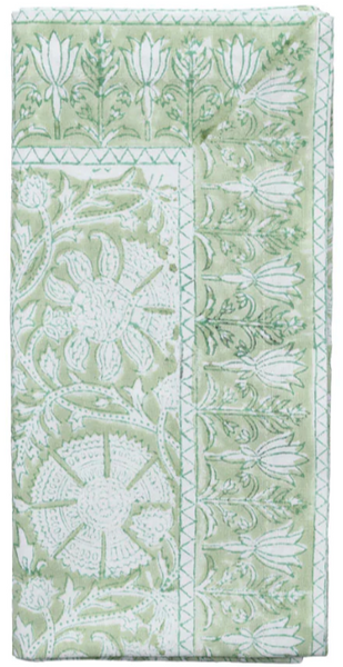 A folded green and white textile with intricate floral and geometric patterns evokes a county-inspired setting, reminiscent of a whimsical Kim Seybert Provence, Set of 4 Napkins.