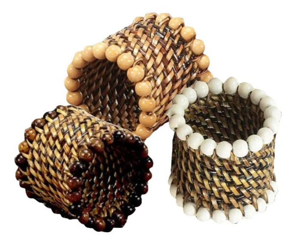 Displayed upright are three cylindrical Calaisio Round Beaded Napkin Rings in brown and white, handcrafted by skilled artisans. These elegant pieces from Calaisio feature bead accents and intricate detailing with water-vines, adding a touch of natural beauty.