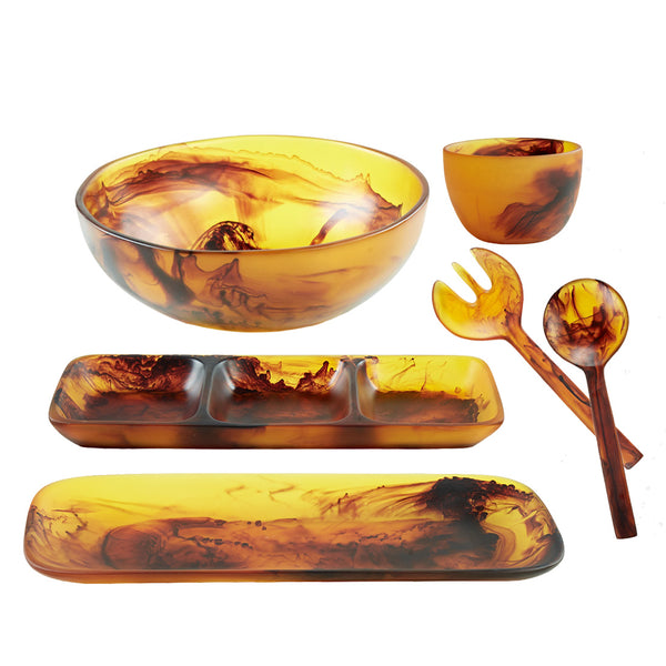 Introducing the Nashi Home Tortoise Serveware Collection, a stunning set of amber-colored resin kitchenware that features a beautiful marbled pattern. This collection includes a bowl, cup, divided tray, long tray, and salad servers. Each piece in the Nashi Home collection offers unique shapes and sizes with shatter-resistant durability, ensuring lasting elegance for your culinary presentation.