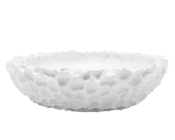 The Dara Bowl by Made Goods is a coral-inspired, matte white resin bowl featuring an irregular, rough surface and shallow depth.