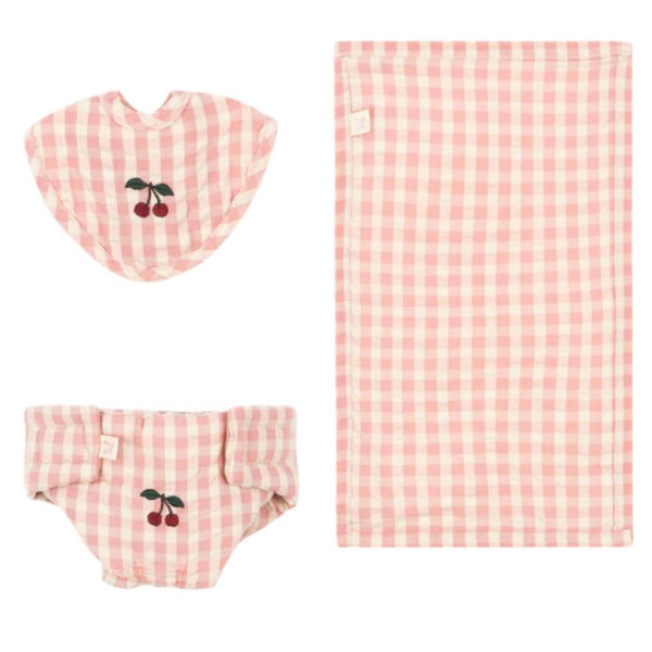 The Konges Slojd Doll Nursery Set by Konges Slojd is a delightful collection of pink and white checkered baby accessories, crafted from 100% cotton. This charming set includes a cherry-adorned bib, a matching diaper cover, and an adorable blanket, making it perfect for any doll nursery setup.