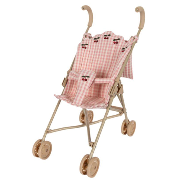 The Konges Slojd Doll Stroller by Konges Slojd features a pink and white checkered pattern with cherry print accents, a beige frame, matching double wheels, and a secure harness for the doll.