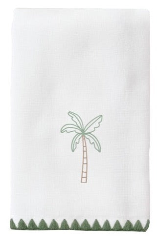 A Weezie Towels Weezie Towel Palm Tree Green Stitched Guest Towel with a small palm tree illustration in the center and a green scalloped border at the bottom edge, perfect for any hostess.