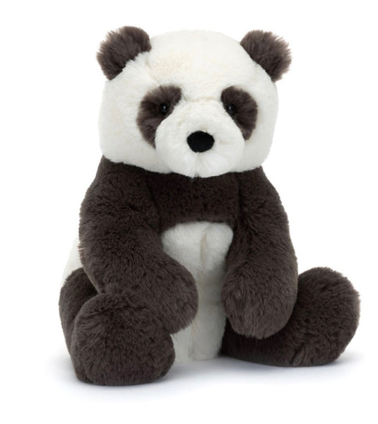 A Jellycat Harry Panda Cub, Medium with beary snuggly, black and white fur sits upright on a plain background.