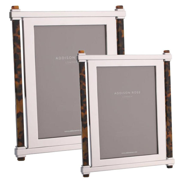 Two frames from the Addison Ross Faux Tortoise Pillar & Silver Frame Collection, one larger and one smaller, both displaying placeholder text. Each Addison Ross frame features a luxurious velvet backstand, adding an elegant touch to their sophisticated design.