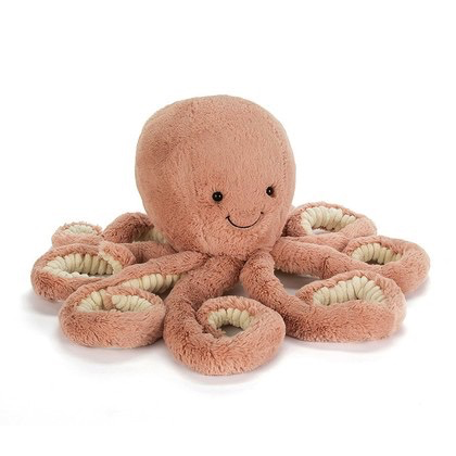 Jellycat Odell Octopus, Little, a plush pink toy with a smiling face, eight arms, and cream-colored inner tentacles, sits upright facing forward. Known for giving the best hugs in the ocean, this cheerful companion brightens any room.