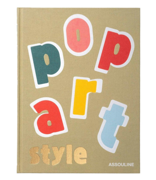 The **Pop Art Style** by **Assouline** features a beige book cover with colorful block letters spelling "Pop Art" and the word "Style" in gold at the bottom right. The publisher's name, "ASSOULINE," is also in gold. This design captures the vibrant essence of Pop Art Style, reminiscent of the 1960s and ’70s pop culture era.