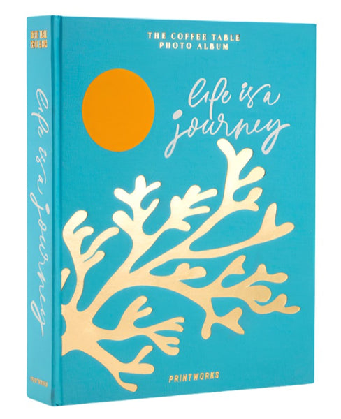 Introducing the PrintWorks Life Is A Journey Photo Album, crafted from recycled greyboard and adorned with a decorative gold coral design on its teal cover. Inside, you'll find high-quality black photo paper to preserve your cherished memories beautifully.