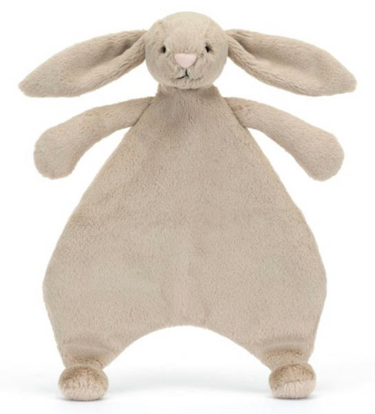 A plush toy shaped like a rabbit, with floppy ears, small arms, and a soft triangular body, made from beige fabric and recycled fibres. This Jellycat Bashful Beige Bunny Comforter is perfect for cuddles.