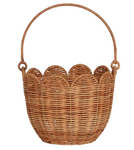 The Olli Ella Rattan Tulip Carry Basket from Olli Ella is a handwoven rattan basket adorned with a looped handle and scalloped edge design, making it an ideal choice for nursery decor.