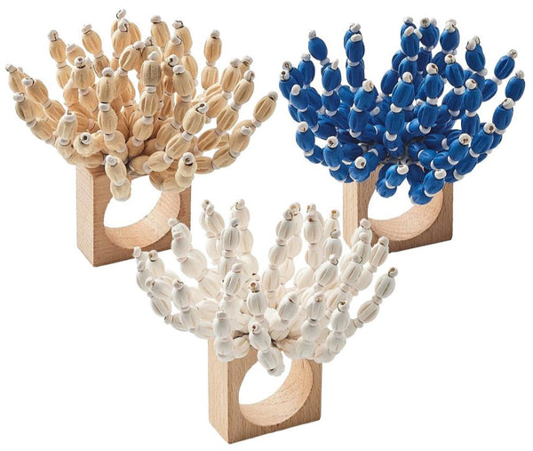 The Kim Seybert Reed Napkin Ring, available in beige, blue, and white colors with three ring bases topped with polyps that resemble natural coral branches, is perfect for adding a coastal-inspired touch to your beach-themed decor.