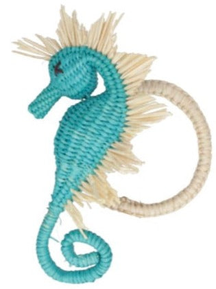 Experience a coastal charm in your everyday essentials with the Mercedes Salazar Sea Horse Napkin Ring Collection by Mercedes Salazar. This handmade, blue-and-cream woven seahorse, featuring intricate detailing and a loop for keys, serves as a functional yet stunning accessory.