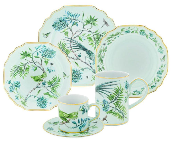 The Aquazzura Secret Garden Collection by Aquazzura Casa consists of five porcelain pieces featuring a garden-motif design with birds and flowers. This exquisite set includes plates, a saucer, and two mugs, all adorned in a light green color with gold accents.