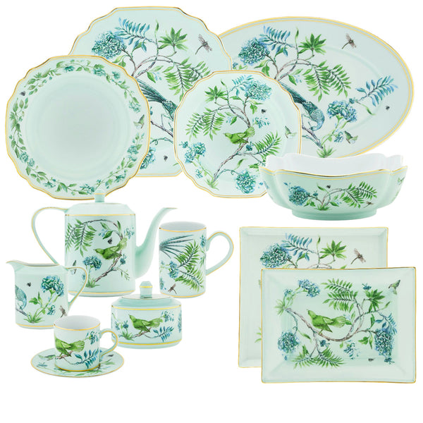 Introducing the Aquazzura Secret Garden Collection from Aquazzura Casa: a captivating set of white porcelain dishes featuring green floral and bird designs inspired by a garden motif. This exquisite ensemble includes plates, a teapot, cups, and saucers, all elegantly finished with gold trim.