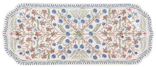 This versatile tray is a rectangular ceramic piece with scalloped edges, showcasing an intricate Seville floral motif in blue, pink, and green designs on a white background. Perfect for adding a touch of the Spanish countryside to your home decor, the Juliska Villa Seville Chambray Hostess Tray by Juliska.