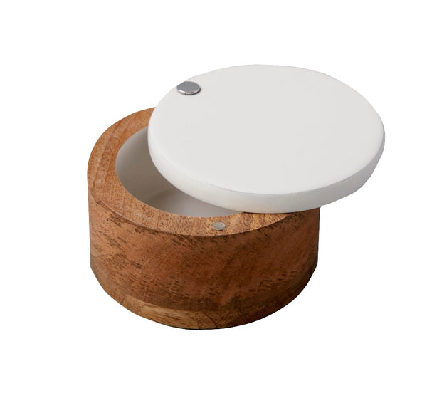 A small, round handcrafted wooden container with a white lid slightly open, revealing an empty interior. This exquisite piece, known as the Be Home Madras Classic Spice Cellar, is made from rich mango wood.