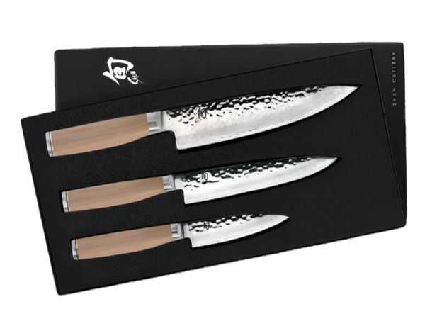 The Shun Premier Blonde Starter Knife Set, a 3-piece collection from Shun, showcases three stunning kitchen knives with Damascus cladding and VG-MAX cutting cores. The hammered, polished blades are strikingly complemented by light-colored handles, all elegantly showcased in a chic black box.