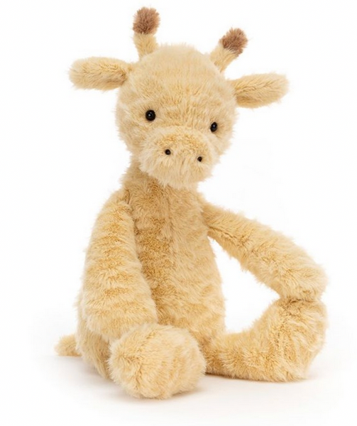 A fluffy, light-brown Jellycat Rolie Polie Giraffe sits upright with its front legs bent. The giraffe has small, fluffy ossicones and a soft expression, making it perfect for cuddles and baby-friendly playtime.