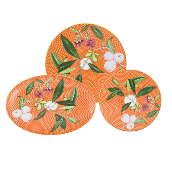 Introducing the Raynaud Tresor Fleuri Orange Collection by Raynaud: a set of three exquisitely designed plates showcasing a botanical motif with green leaves and white flowers. Hand-painted on fine porcelain, this sophisticated collection includes two round plates and one oval plate in varying sizes.