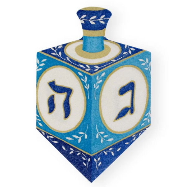 Caspari Dreidel Luncheon Napkins feature a blue and white design with Hebrew letters, floral patterns, and are crafted using non-toxic inks.