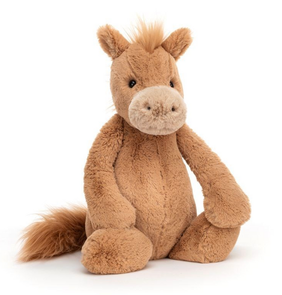 A plush toy horse with light brown fur is seated. It has a light beige snout, a fluffy, silky mane, and soft hooves. This Jellycat Bashful Pony, Huge also features a tail to complete its adorable look.