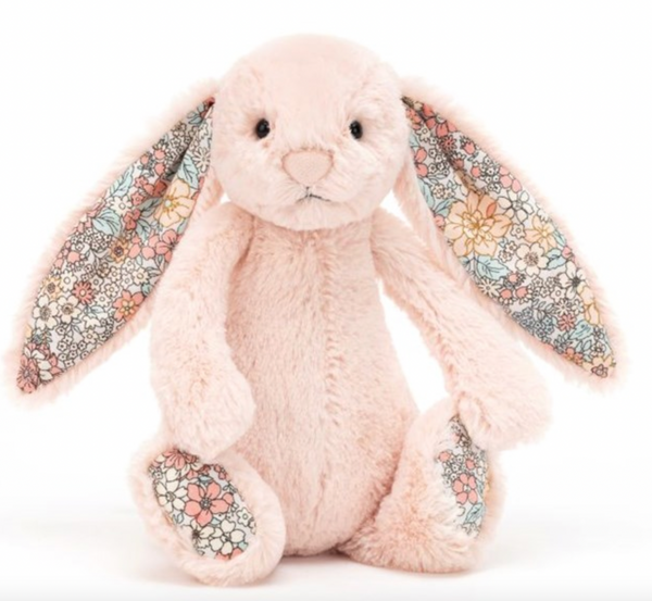 A Jellycat Blossom Blush Bunny, Small with plush pink fur and patterned floral fabric on its inner ears and paws sits upright on a white background, making a delightful springtime bunny.