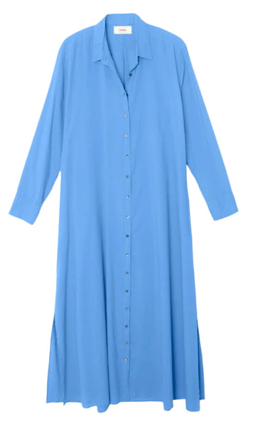 The Xirena Boden Dress by Xirena is a long-sleeved, button-up, blue tailored shirtdress crafted from lightweight woven cotton. It features a collar, extends to the ankles, and includes side slits near the bottom.