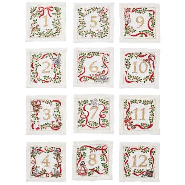 Set of 12 Kim Seybert Christmas Carol Cocktail Napkins, adorned with embroidered holly and red ribbons, perfect for holiday gatherings with their festive, numbered decorations.