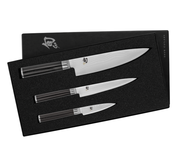 The Shun Classic Ebony Starter Knife Set, 3-Piece, showcases a trio of knives with black handles, beautifully arranged in a sophisticated black foam packaging. Built with a VG-MAX cutting core for exceptional performance, these knives are indispensable for any dedicated chef.