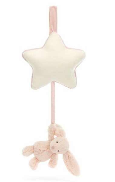 A Jellycat Bashful Blush Bunny Musical Pull, hanging from a star by a fabric strap, offers the perfect newborn gift with its plush design; pull gently to enjoy a soothing musical tune.