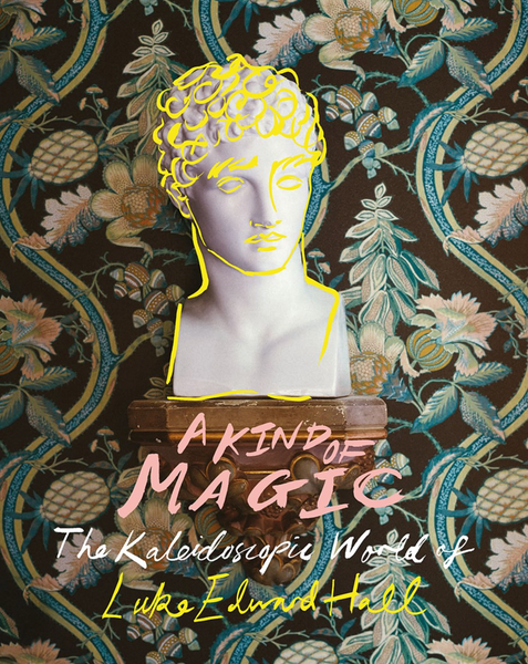 A bust sculpture with vibrant yellow outlines is set against a patterned floral background. The text reads, "A Kind of Magic: The Kaleidoscopic World of Luke Edward Hall," encapsulating his whimsical style and flair for interior design, a product by Common Ground.