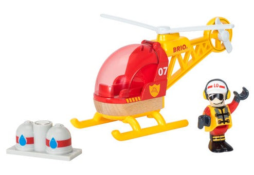 Brio World Firefighter Helicopter by Brio, with red accents labeled "07," a rescue figure wearing a helmet and fire gear, and two water containers for the water supply. The set appears designed for imaginative play.