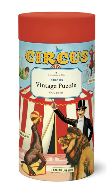 The Cavallini & Co. Circus 1,000 Piece Puzzle by Cavallini Papers and Co. showcases delightful vintage circus-themed illustrations of a seal balancing a ball, a lion, and a ringmaster.