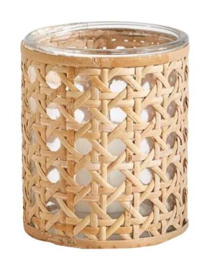 A small, cylindrical candleholder crafted from natural cane webbing with a glass interior: Two's Company Lumingnon Cane Webbing Tealight Candleholder.