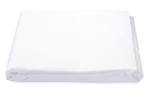 White Matouk Ceylon Fitted Sheet isolated on a green background.