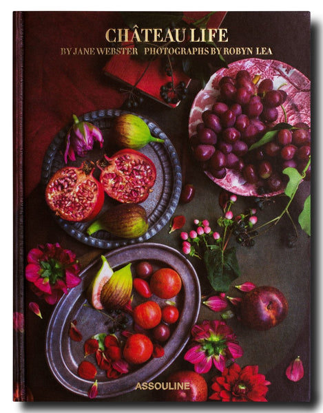 Cover of the book "Chateau Life" by Assouline, featuring photographs by Robyn Lea. The cover displays a dark, richly colored assortment of fruits and flowers on a table, evoking the culinary traditions of Château Bosgouet.