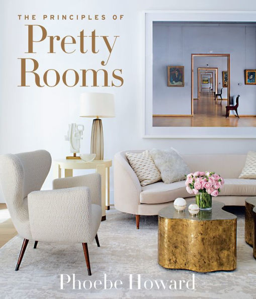 Cover of the book "The Principles of Pretty Rooms" by Common Ground, showcasing a stylish living room adorned with soft, neutral-toned furniture, a brass coffee table, and framed artwork in the background. Explore interior designer Phoebe Howard’s décor secrets within its pages.