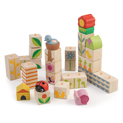 The Tenderleaf Garden Blocks from Tender Leaf Toys feature a nature theme with colorful patterns and animal designs, including a ladybug, duck, and snail. These push-and-click blocks can be stacked and arranged in various configurations for endless fun.