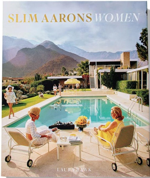 The cover of "Slim Aarons Women" by Abrams showcases remarkable women from high society, gracefully seated by a serene pool with grand mountains in the distance.