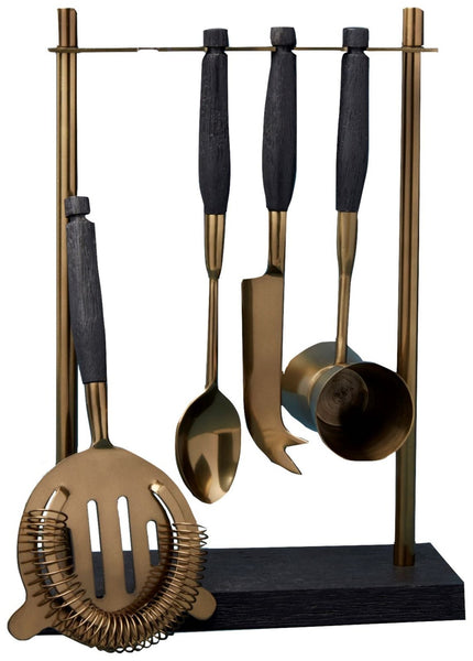 A stand of handcrafted mango wood holds four gold and black bar tools: a strainer, a spoon, a knife, and a jigger. This elegantly designed Be Home Black Mango Wood and Bronze Hanging Bar Tool Set by Be Home adds a touch of class to any setting.